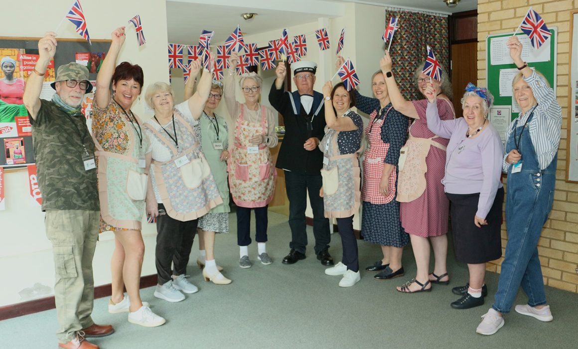 A group of people in fancy dress at a VE Day celebration