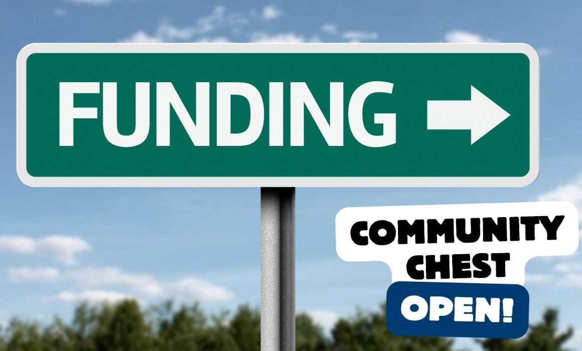 A road sign against a blue sky, which reads 'Funding'. The text 'Community Chest open' is overlaid.